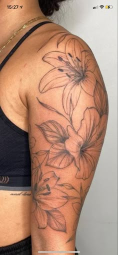 a woman's arm with flowers on it and the bottom half of her arm