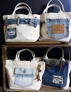 three bags are stacked on top of each other in front of a shelf with two pairs of jeans