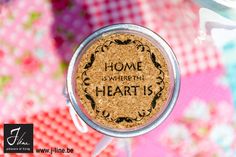 there is a cork with the words home is where the heart is