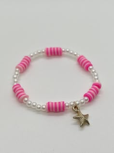 Handmade 7 in. preppy beaded bracelet. Contains pink and light pink 6mm beads. This bracelet also has cute pearl beads, and a starfish charm! I think this bracelet is perfect for summer, or any time of the year! You can buy this for yourself, or as a gift! I can custom create a bracelet for you. Just let me know what colors you want, and if you want a word on your bracelet. I can also make phone charms and rings. Cute Ideas For Bracelets, Pink Bracelets Ideas, Polymer Clay Bead Ideas, Bread Bracelet Ideas, Cute Bracelet Ideas For Summer, Cute Bracelets Ideas Beads, Clay Braclets Idea, Clay Beads Bracelet Ideas, Cool Bracelet Ideas