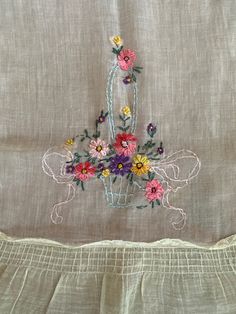 an embroidered piece of cloth with flowers on it