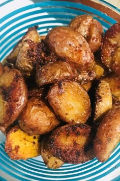 a blue and white bowl filled with fried potatoes