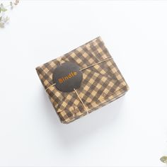 a brown and white checkered wrapping paper with a black circle on the top that says bundle