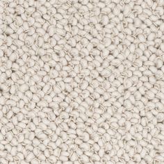 an up close shot of the texture of a carpet with white and beige colors on it