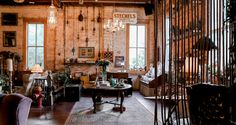 a living room filled with furniture and lots of windows