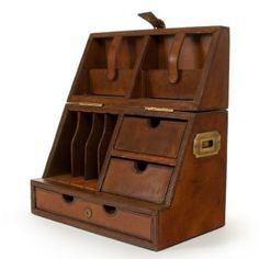 an old fashioned wooden desk with drawers and compartments on the bottom, in brown leather