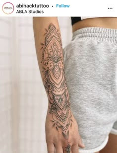 a woman's arm with a tattoo on it and a flower in the middle