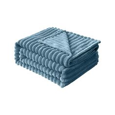 blue towels stacked on top of each other in front of a white background and one folded up