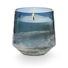 a candle that is sitting in the middle of a glass cup with water inside it