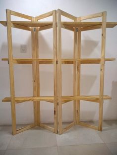 a room divider made out of wood with shelves on each side and one section open