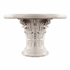 an antique white marble pedestal with intricate carvings on the top and base, isolated against a white background