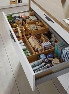 an open drawer in the middle of a kitchen