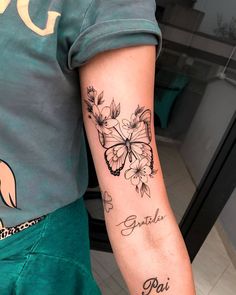 a person with a butterfly tattoo on their arm and the words, butterflies, paris written in cursive writing