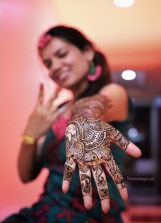 a woman with henna on her hand