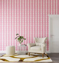 a living room with pink and white wallpaper, two chairs and a rug on the floor