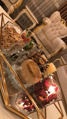 a glass tray with food on it sitting on a table in front of a couch