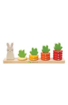 the wooden toy is set up to look like carrots and cactus plants with numbers on them