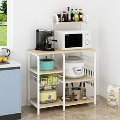 a microwave oven sitting on top of a white shelf next to a counter filled with food