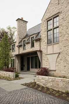 a large stone house with two story windows