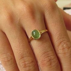 "This Emerald ring is 14k gold ring and a beautiful cabochon green Emerald. The stone set is set vertical to the ring giving an illusion of a bigger stone. This green Emerald ring has a beautiful presentation on the finger. You going to love this combination of green and 14k gold color. This can be a unique jewelry gift ring. The ring base is thin (2 m\"m in the lower part) and slightly widens toward the stone, encompassing the whole stone in a gentle gold circle. The stone color is a Emerald gr 14k Gold Ruby Ring, Gold Jewelry Gift, Ruby Ring Gold, Green Tourmaline Ring, Green Emerald Ring, Gift For Daughter