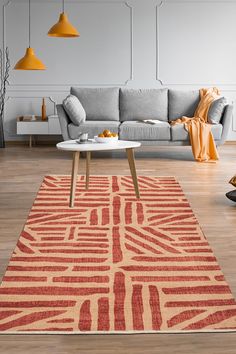 a living room with a couch, coffee table and rug