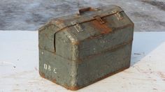 an old metal box sitting on the ground