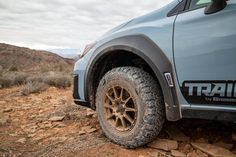 the front end of a truck on a rocky terrain