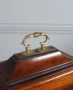 an ornate wooden box with brass handles