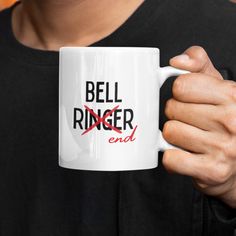 a person holding a coffee mug with the words bell ringer end on it