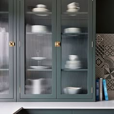 a china cabinet with glass doors and plates on it