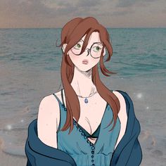 a woman with glasses is standing on the beach