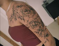 a woman's arm with flowers on it, and the back of her body