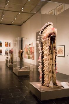 an art gallery with various pieces of clothing on display