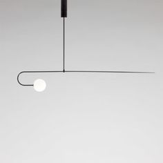 a black and white photo of a light hanging from a ceiling fixture in a room