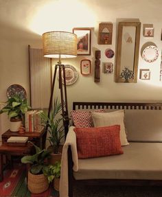 a living room filled with furniture and pictures on the wall