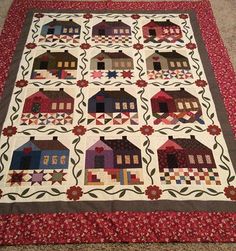 a quilted table runner with houses on it