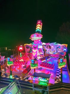 an amusement park at night with rides lit up