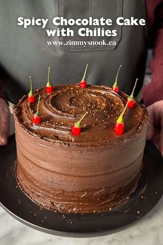 a chocolate cake with cherries on top and the words spicy chocolate cake with chilis