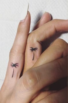 two palm trees on their fingers with one holding the other's hand and another behind them