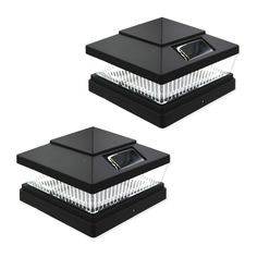 two black plastic boxes with lids on them