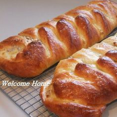 two loaves of bread sitting on top of a cooling rack