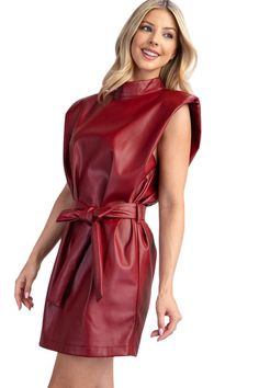 Get ready to turn heads in our Striking Love Oxblood Faux Leather Dress. The deep red color exudes confidence and the added shoulder pads give you a bold silhouette. Plus, the included belt cinches your waist for a flattering fit. Embrace your edgy side with this fierce dress! 55% Polyester 45% PU Model is 5'9" Wearing small Dress With Shoulder Pads, Casual Blouse Shirts, Crop Blazer, Faux Leather Dress, Deep Red Color, Leather Dress, Short Rompers, Blazer Dress, Tie Belt