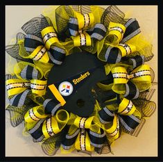 a yellow and black football wreath with a helmet on it