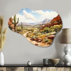 a painting on the wall of a desert with cactus trees and mountains in the background