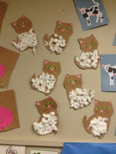 a bulletin board with cat pictures and marshmallows in the shape of animals