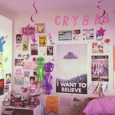 a bedroom with posters and balloons on the wall