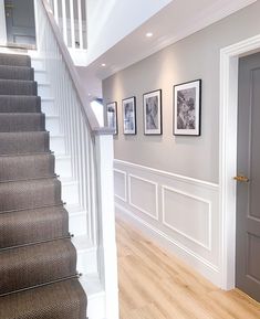 a staircase with pictures on the wall next to it