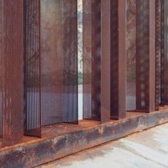 an old rusted metal structure with rocks and trees in the background