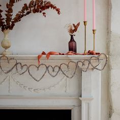 a fireplace mantel with candles and decorations on it