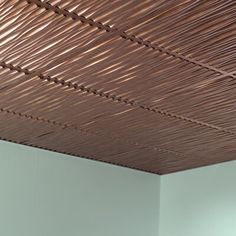 the ceiling is made of bamboo sticks and has a white wall in front of it